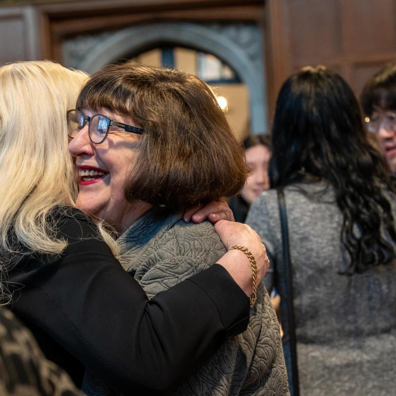 J. Barbara Rose hugging a guest.