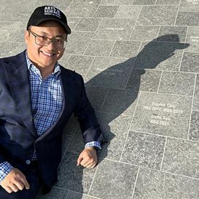 Image of Eugene Choi with Landmark Paver in King's College Circle.
