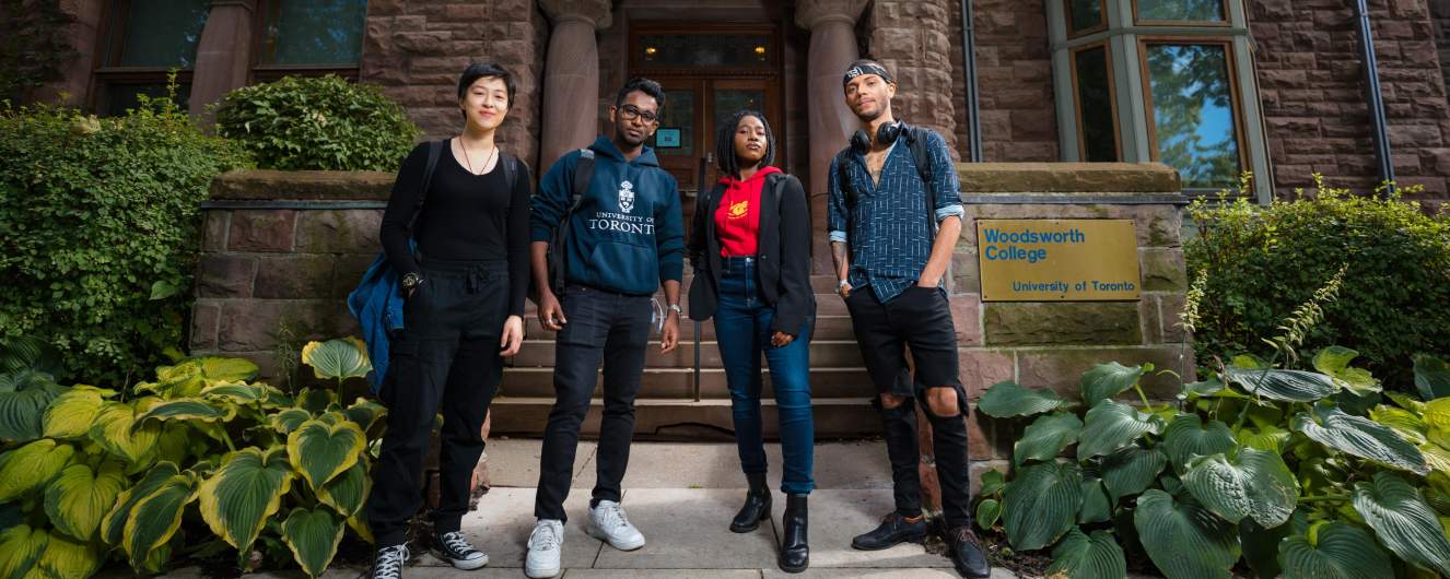 Four Woodsworth students standing in front of the College. 