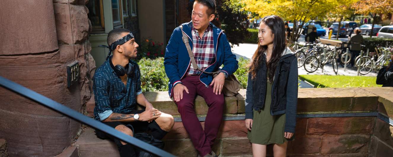 Students sitting on the steps outside of Woodsworth College