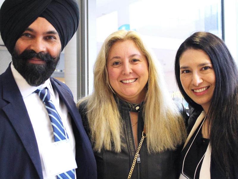 Three Academic Bridging Program graduates at the Bridging graduation event. 