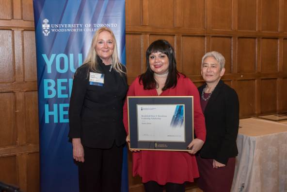 Andrea (middle) stands with Lynda Hamilton (left) and Principal Chin (right), holding her award certificate.