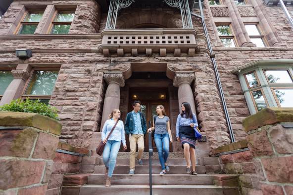 Four students walking down front steps of Woodsworth College
