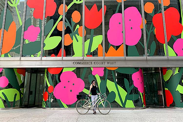 Cavanagh stands in front of her installation “Big City Blooms” at Commerce Court in downtown Toronto.